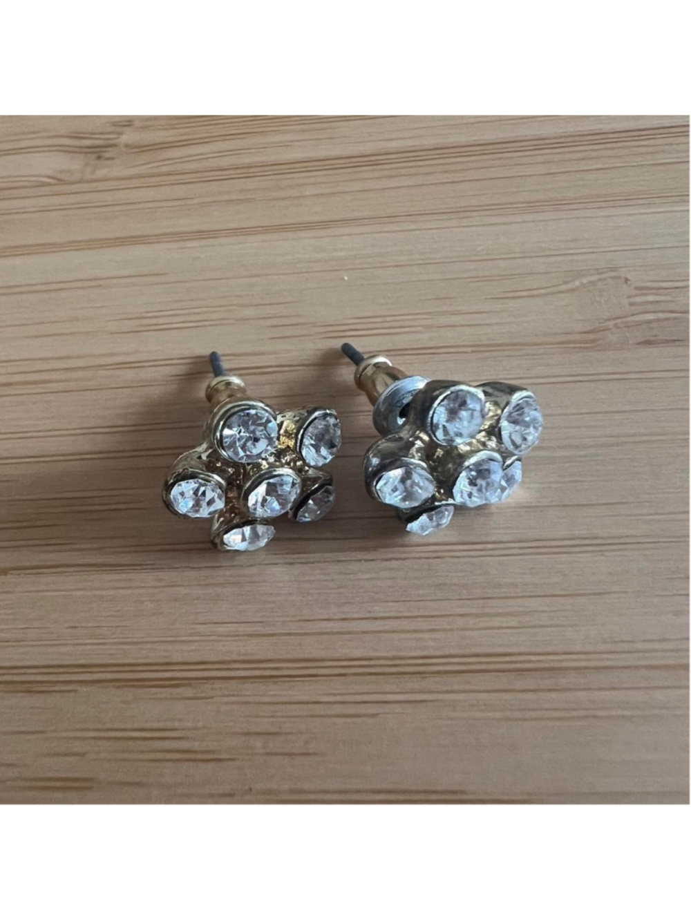 Gold floral stud earrings with rhinestone petals